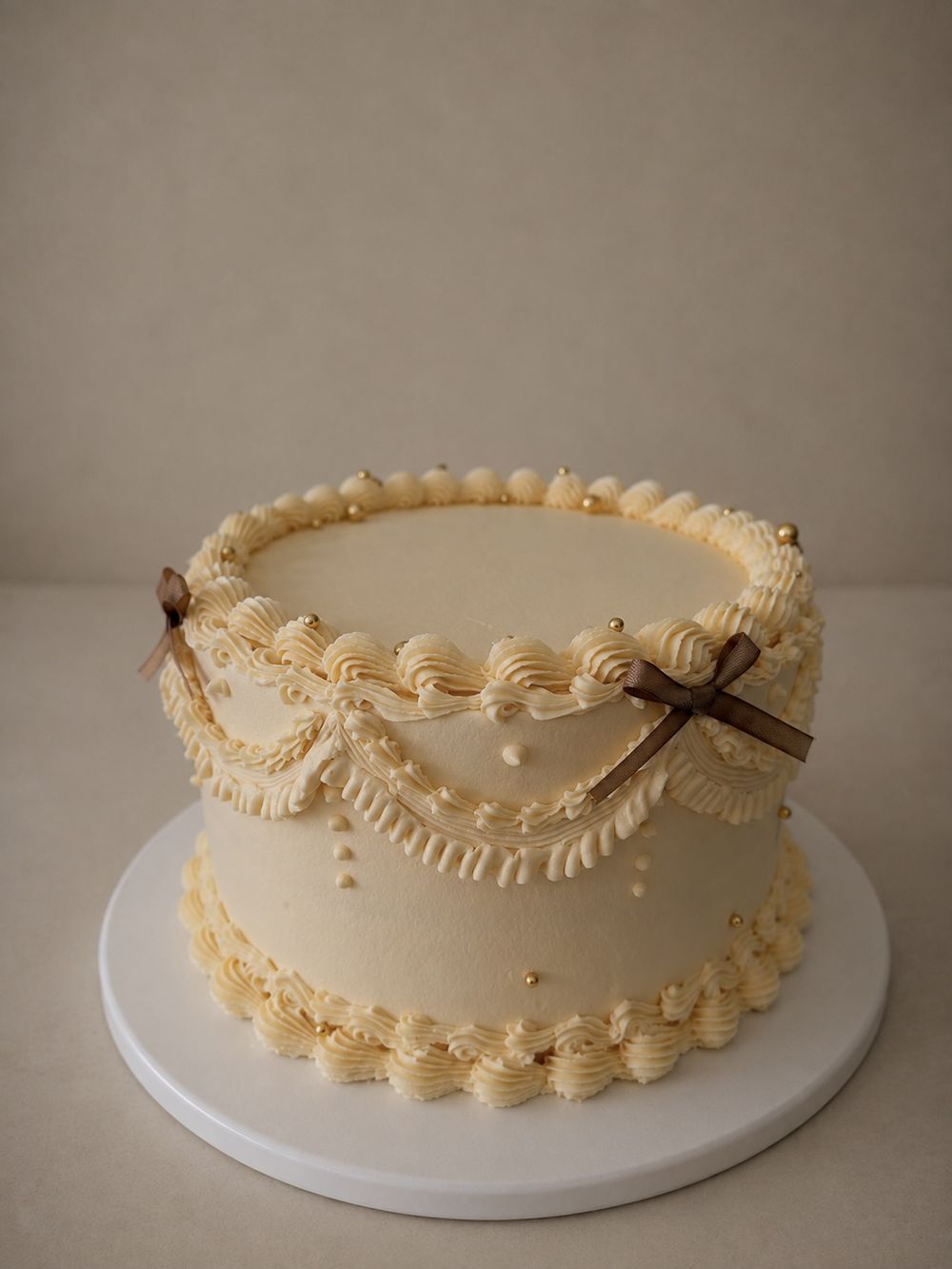 Ivory piped birthday cake with ribbon bows