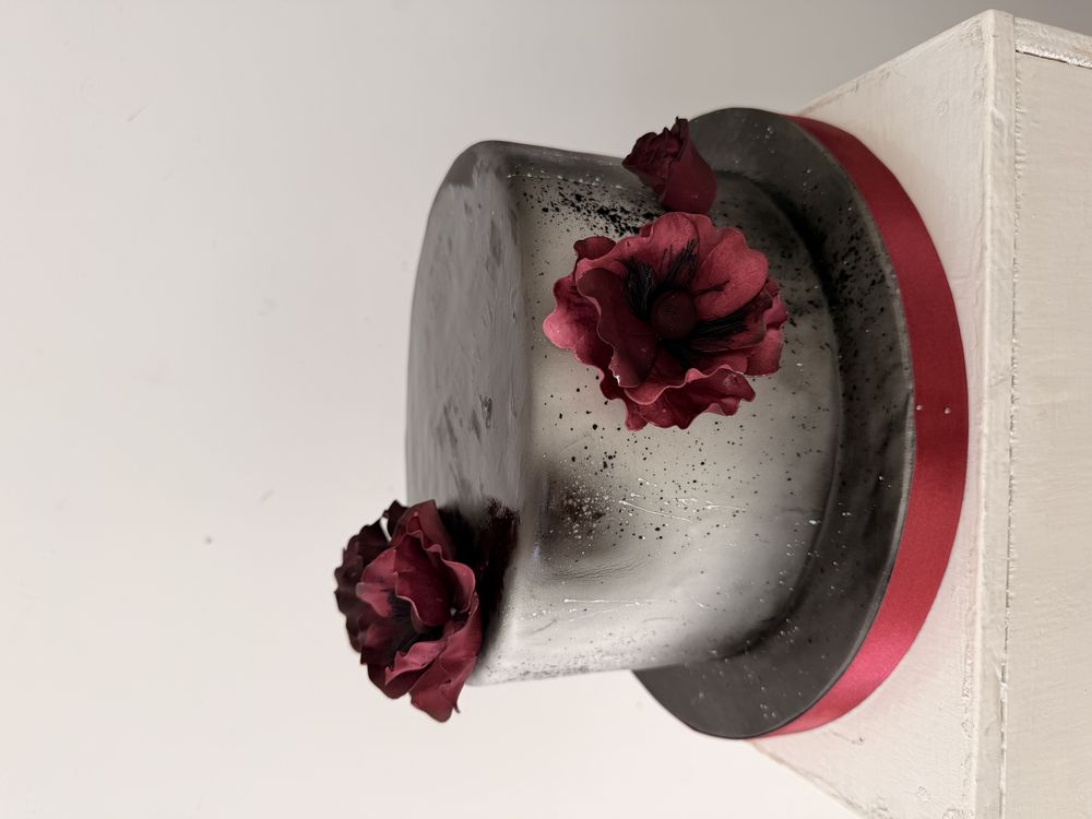 Black marble birthday cake with burgundy flowers