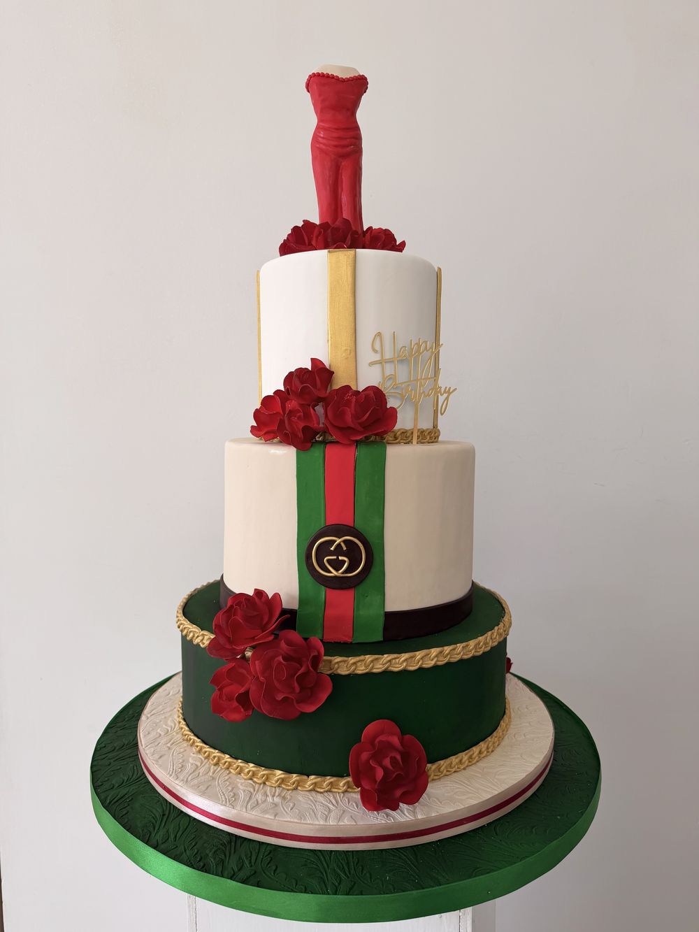 Gucci-themed birthday cake with red roses