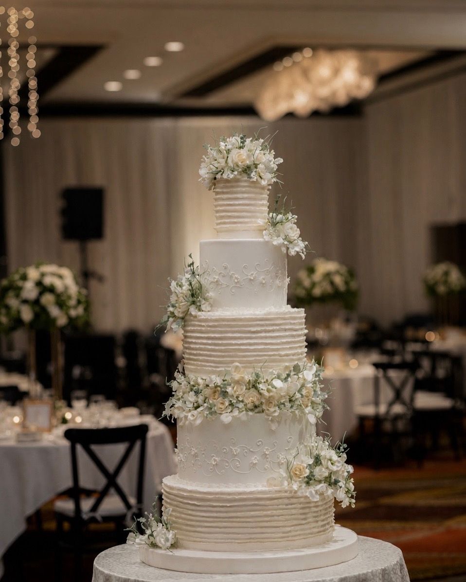 Tall ribbed wedding cake with white florals